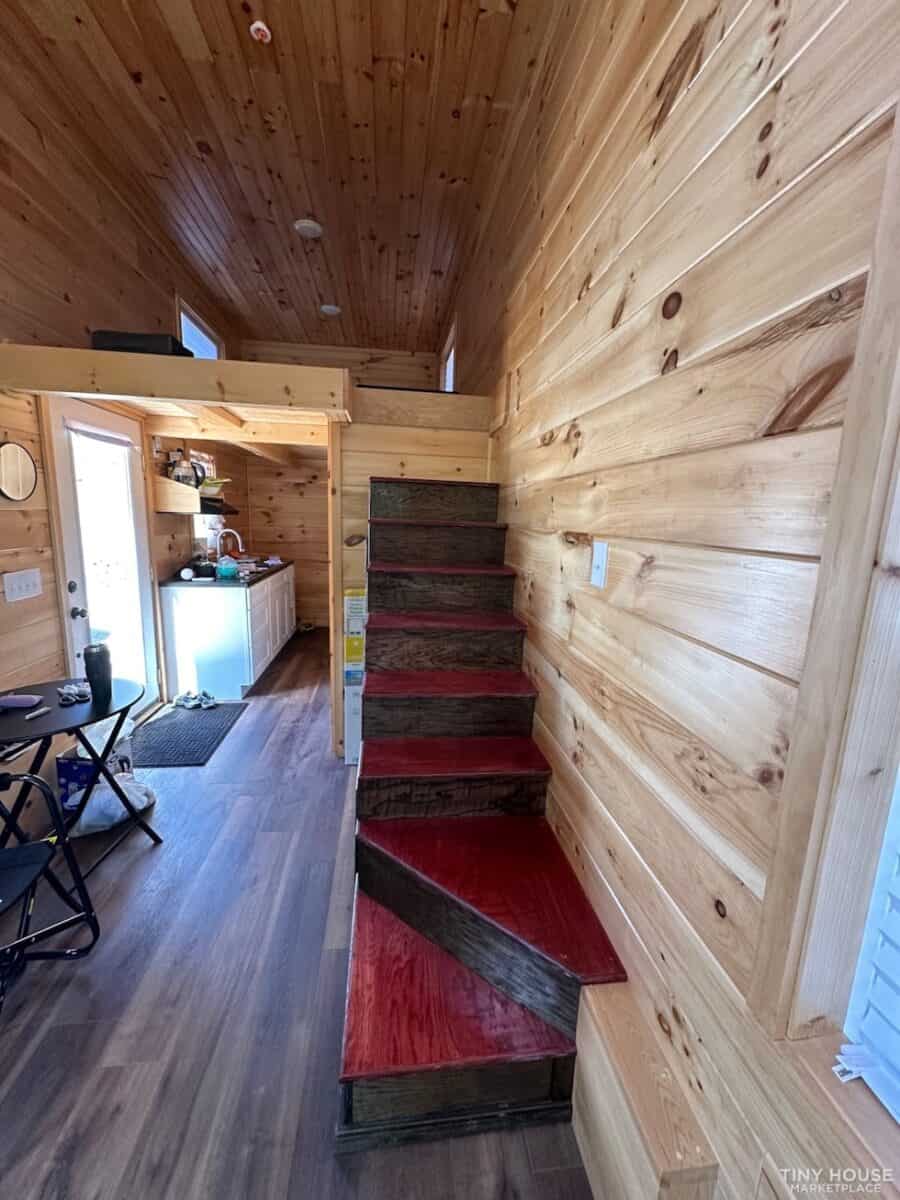 Compact wooden staircase inside tiny house in Tennessee.