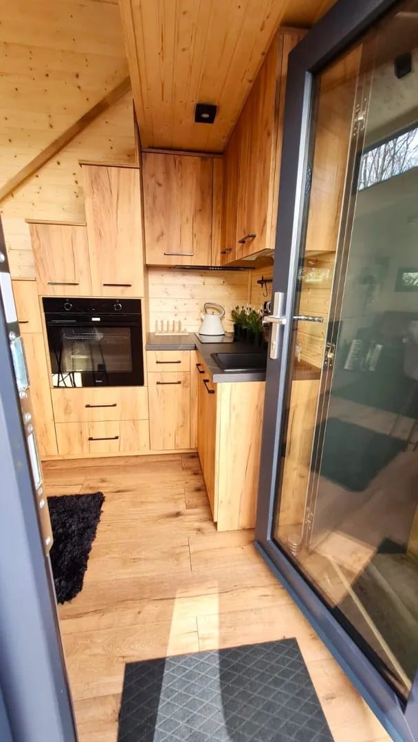 Adams tiny house kitchen beside the glass entry door