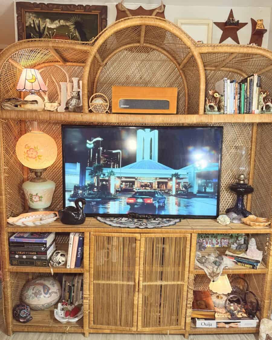 Interior view of a vintage-inspired tiny apartment with rattan furniture and eclectic decor.
