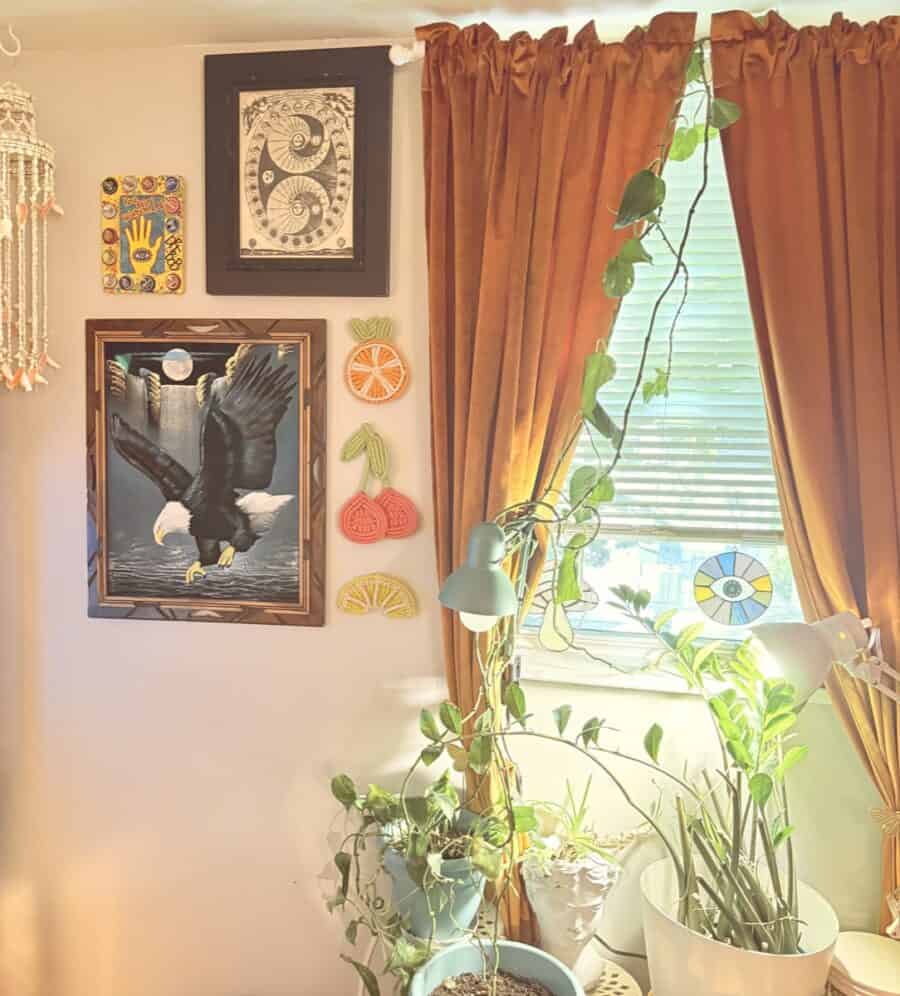 Cozy vintage-filled apartment interior with plants, artwork, and warm curtains in Atlanta.
