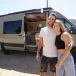 Artistic van with arch-themed design by DIYers, perfect for small space living and travel.