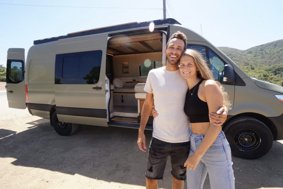 Artistic van with arch-themed design by DIYers, perfect for small space living and travel.