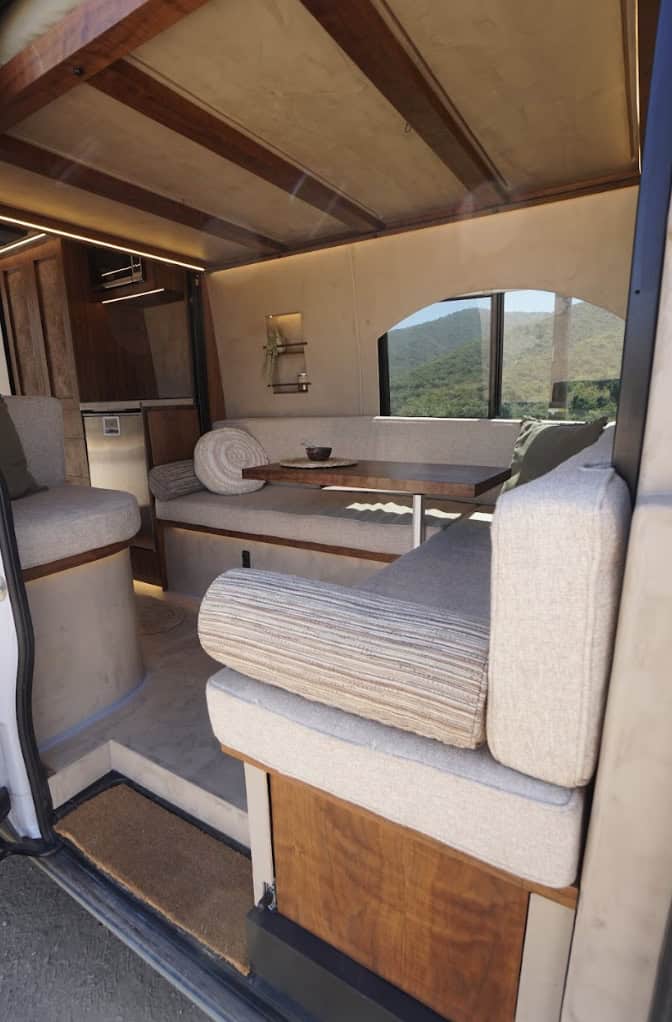 Arch-themed artistic van interior with creative seating and window views.