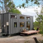 Compact family-friendly tiny house on wheels with modern design and outdoor deck.