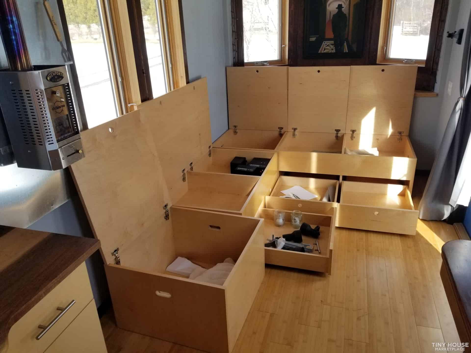 Efficient storage in small spaces with custom-built wooden compartments.