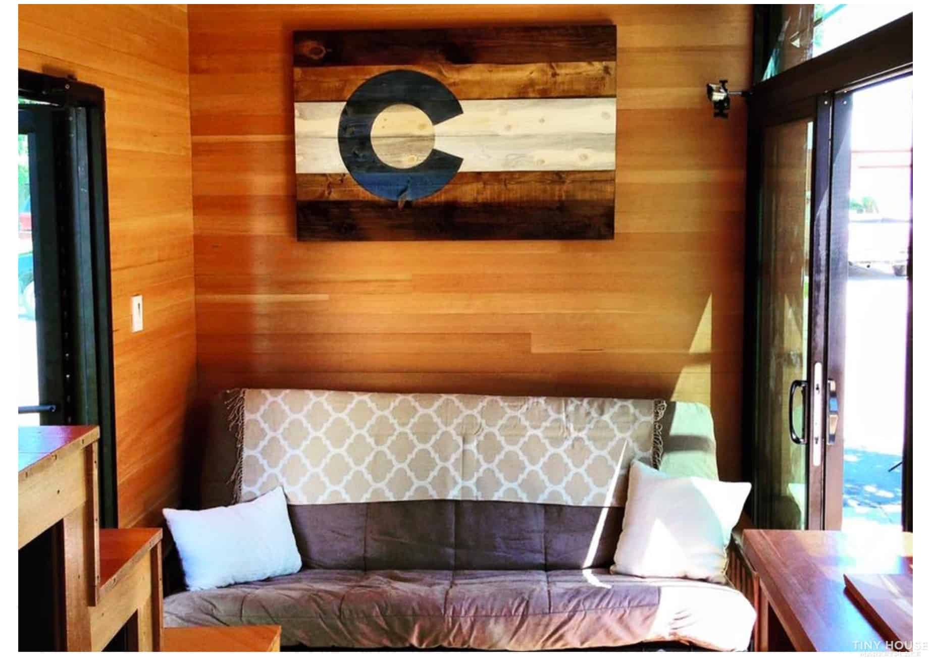 Small living room in a tiny house with wooden walls and modern decor.