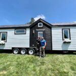 Charming tiny house featuring a spacious first-floor bedroom and modern design, perfect for small sp.