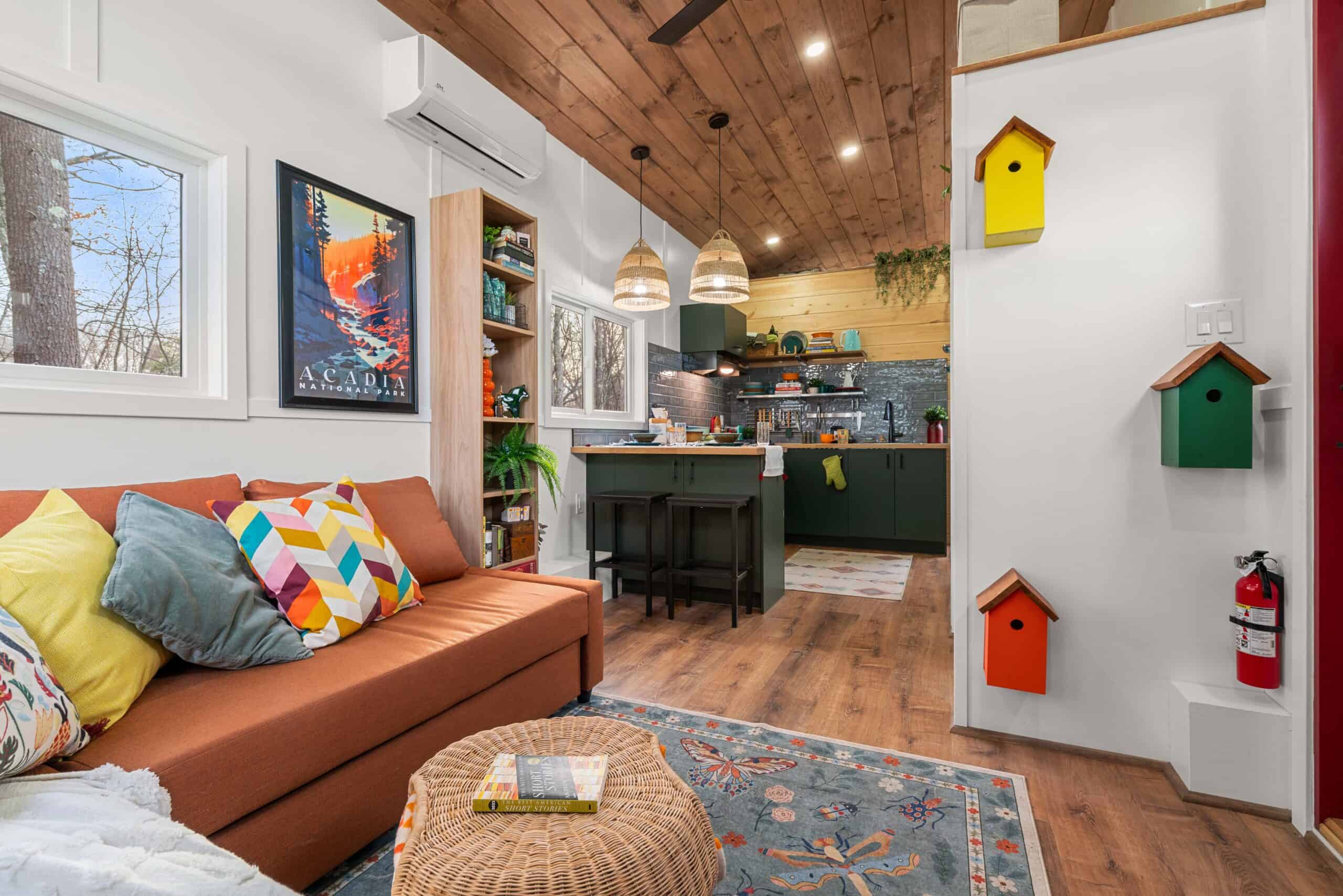 The Knoll's living area and green kitchen with the staircase leading up to the standing-height loft