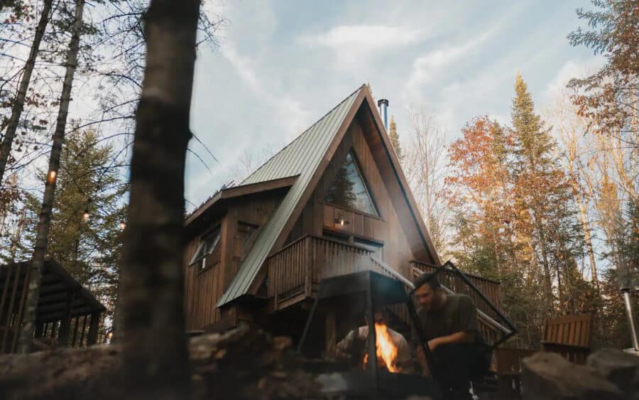 A-Frame cabin in Quebec surrounded by fall foliage, perfect for small space living and outdoor relax.