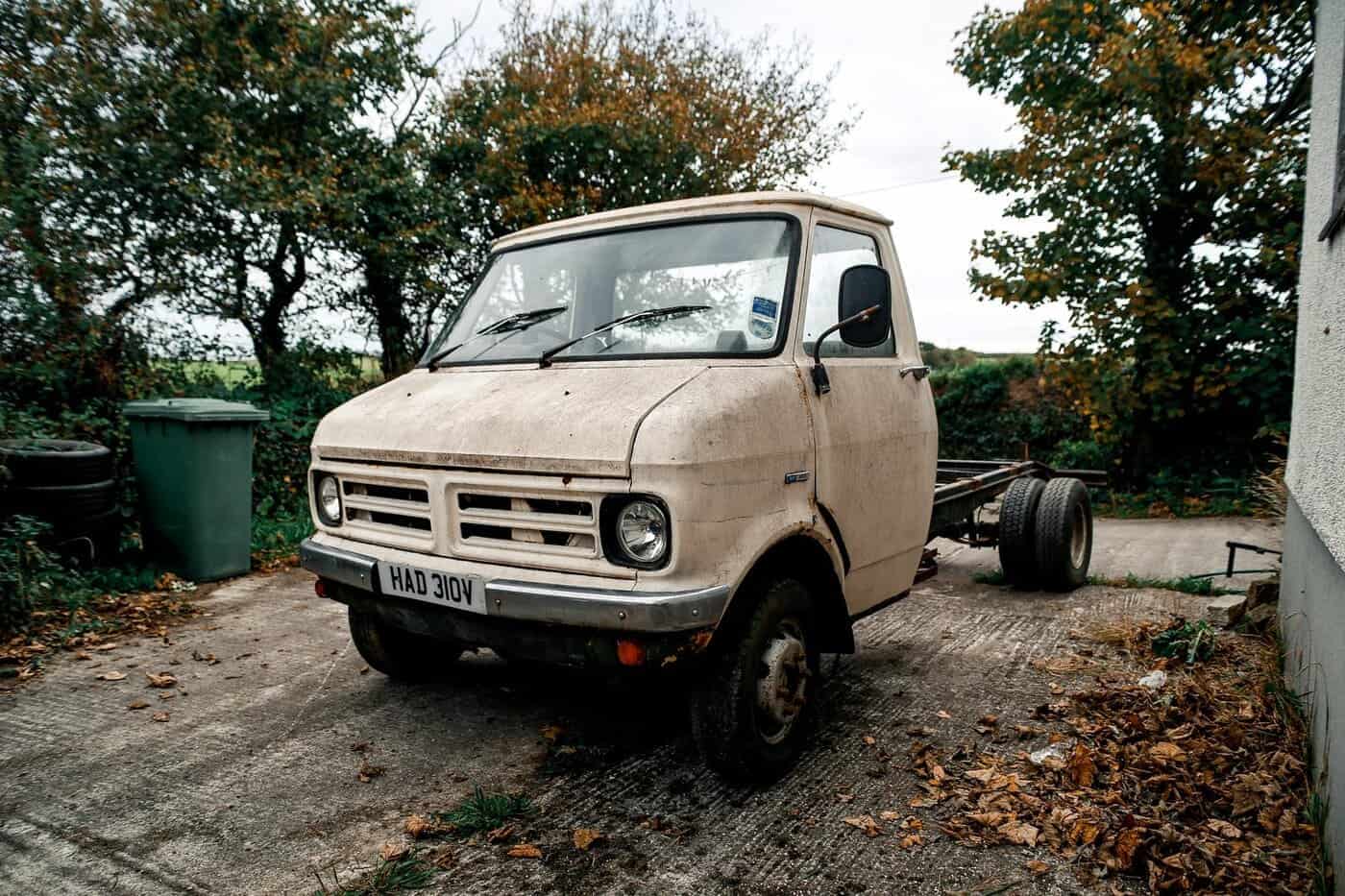 The original 1979 Bedford CF chassis cab before conversion, weathered and parked in a yard