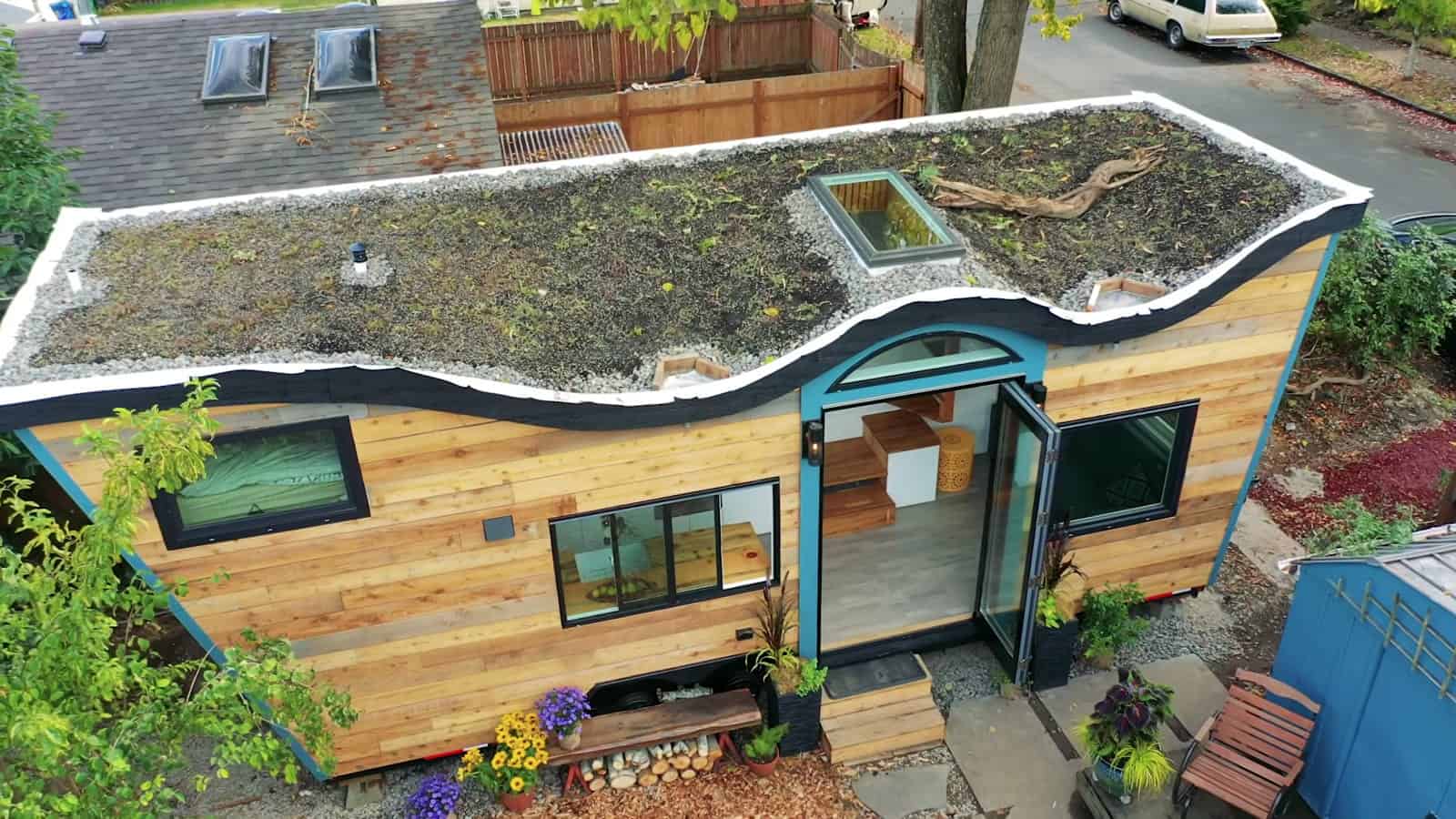 Aerial view of the sedum living roof with skylight on top of the curved-roof tiny house