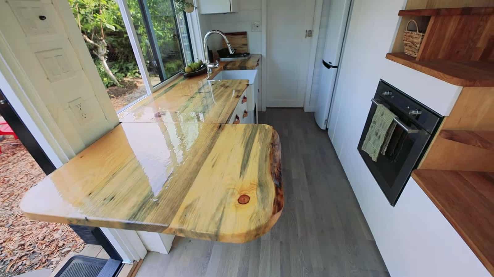 Beetle-kill pine counter with the extension leaf in place to seat three in the tiny house kitchen