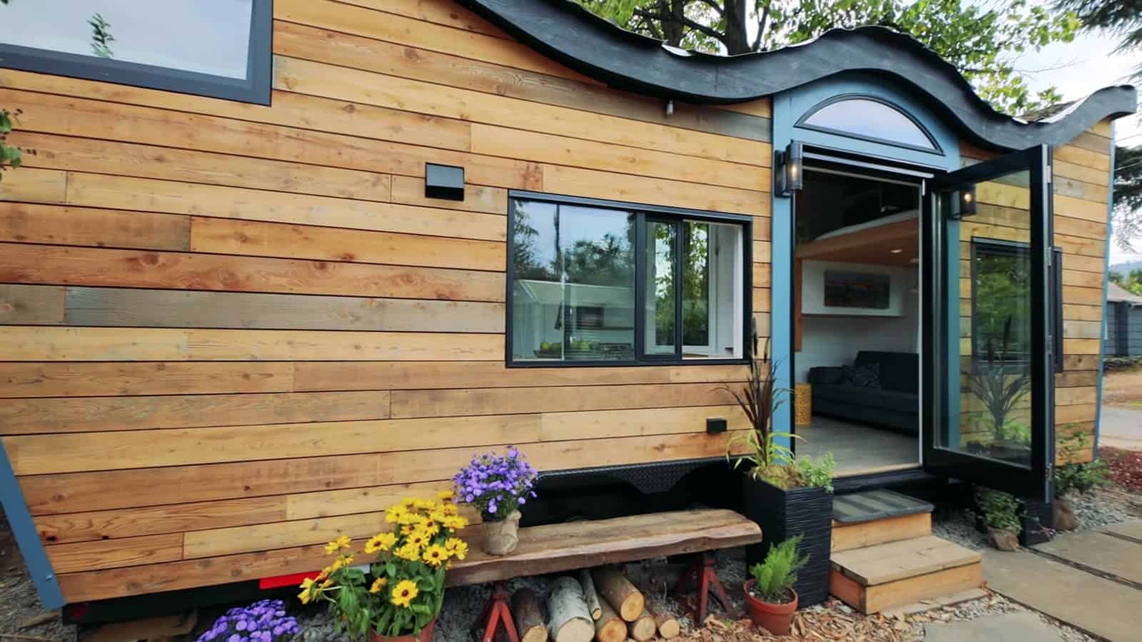 Side view of the Portland tiny house showing the wave-shaped Fibonacci roofline and reclaimed wood siding