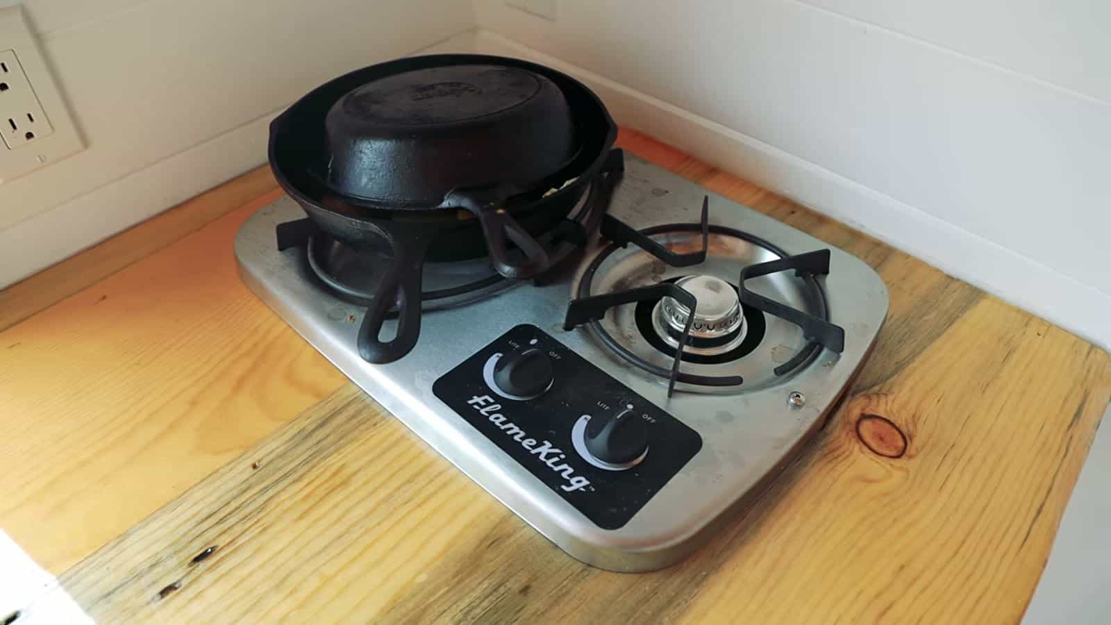 Two-burner propane cooktop on the beetle-kill pine counter for off-grid cooking