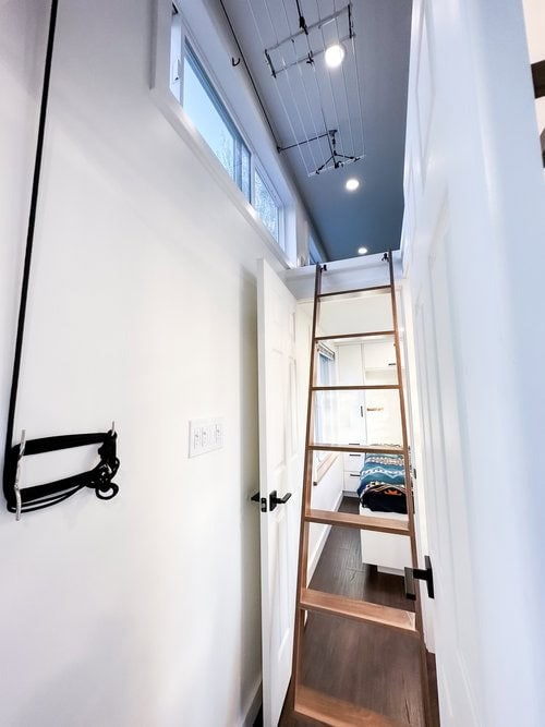 Bright Scandinavian tiny house interior with a loft bed and workspace, featuring minimalist design a.