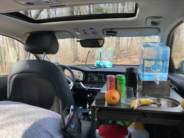 Interior view of Blake's Kia Niro EV stealth camper with small living and cooking space.