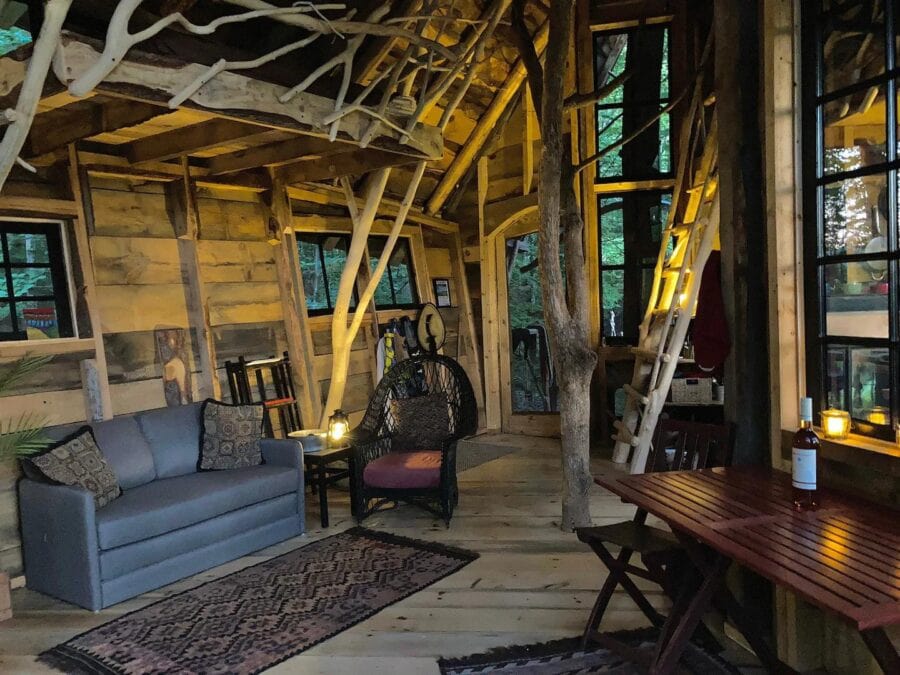 Charming treehouse interior with rustic wood accents and mountain views. Perfect for small space liv.