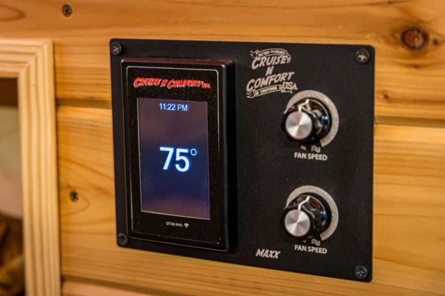 Digital thermostat controlling temperature inside a tiny house.