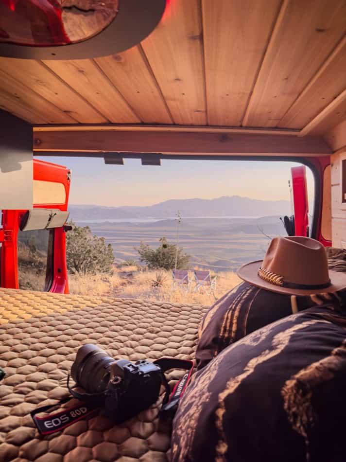 Compact camper van interior with a view of mountains and open landscape, perfect for small space liv.