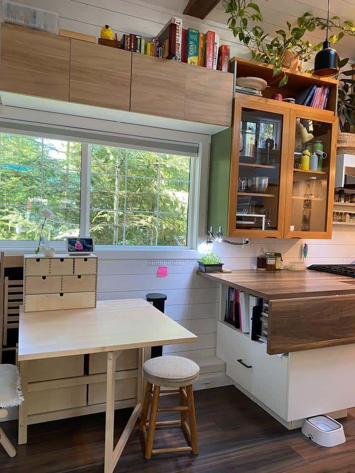 Charming tiny house kitchen with natural light, wooden cabinets, and compact design in a Kootenay co.