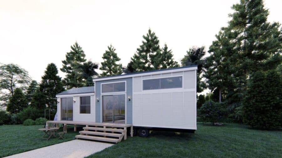 Portable tiny house with sleek exterior and spacious deck for outdoor living.