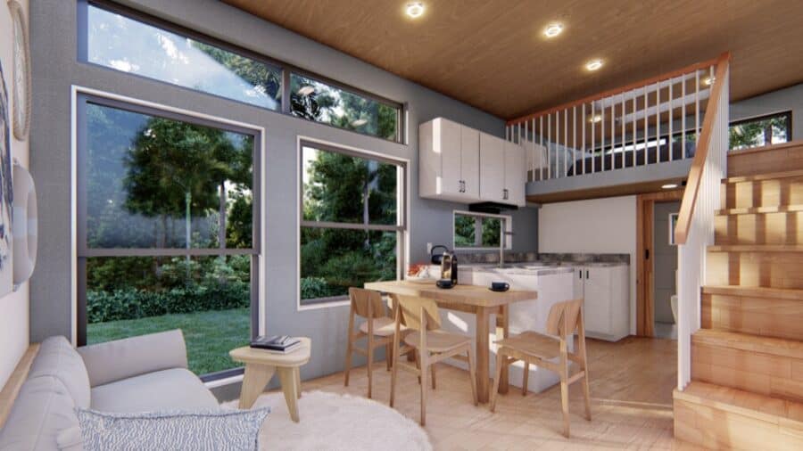 Cozy tiny house interior with large windows and wooden accents.