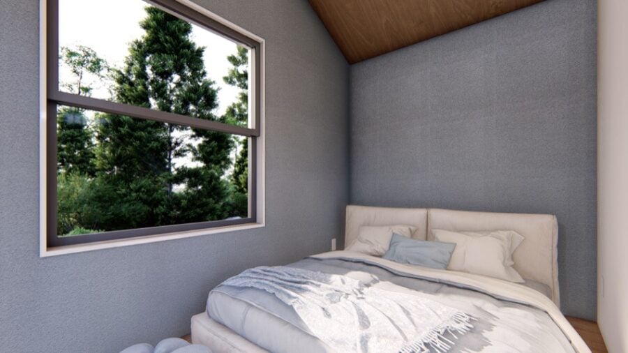 Cozy tiny house bedroom with large window and minimalist decor.