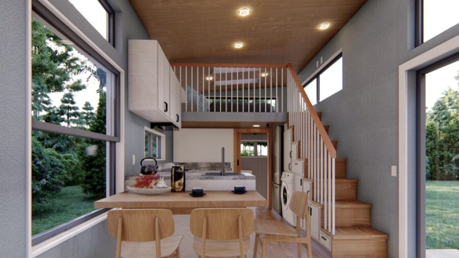 Modern tiny house interior featuring a loft, large windows, and compact kitchen area.