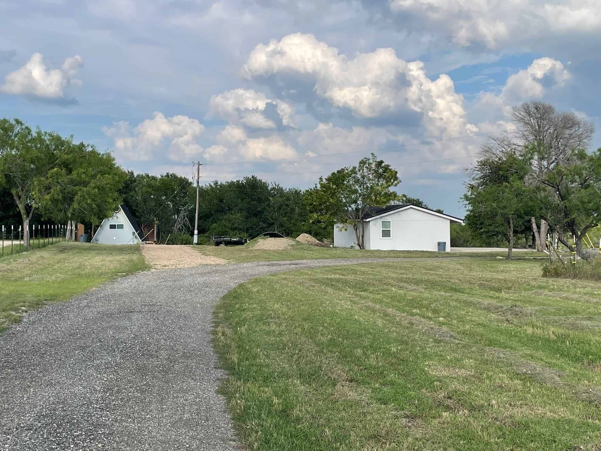 Wide property view showing the A-frame cabin and ranch buildings at Spencer Ranch