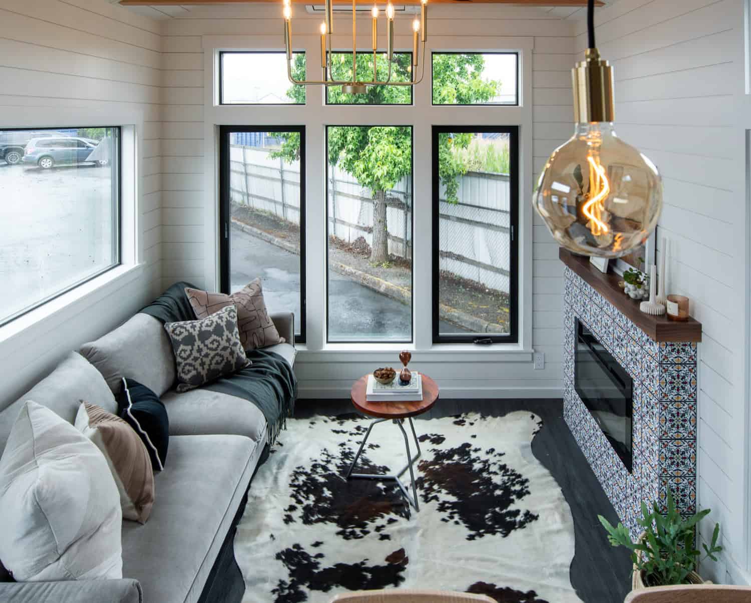 Overhead view of the Cascade Max living room with cowhide rug, fireplace, and large windows