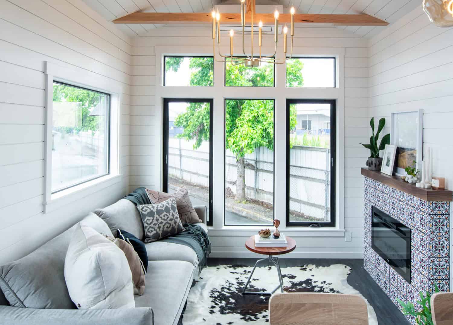 Cascade Max living room with a gray sofa, tall transom windows, and a vaulted shiplap ceiling