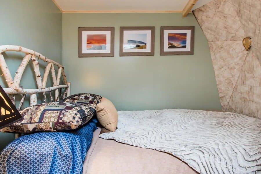 Interior of Catskill Domeo tiny house with birchwood accents and cozy decor.