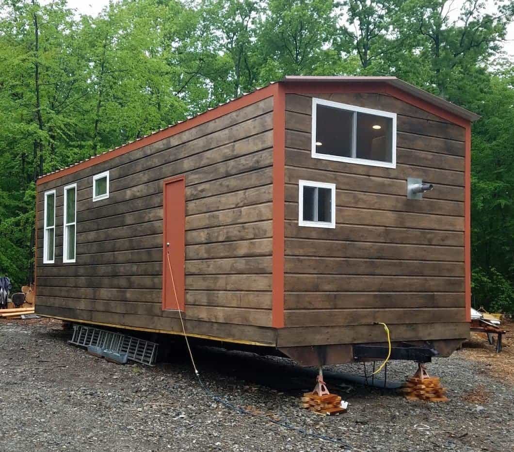 Tiny houses on the wooded hillside at the Catskills Tiny House Workshop in Livingston Manor