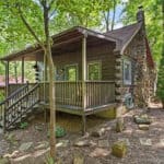 Cozy log cabin in Indiana surrounded by lush trees and nature.