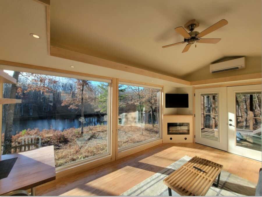 Bright interior with large windows overlooking nature.