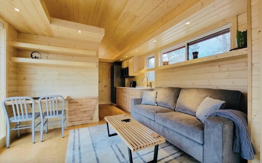 Cozy tiny house interior with wood accents and modern furnishings.