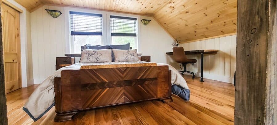 Tiny House Treehouse interior with cozy bedroom and wooden accents.