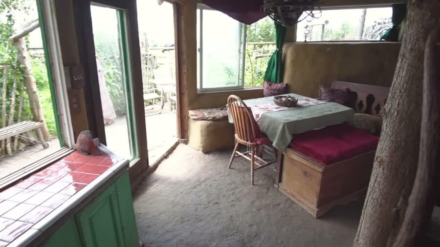 Dining room with earthen floor and salvaged windows