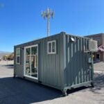 Portable tiny house with large windows and modern design.
