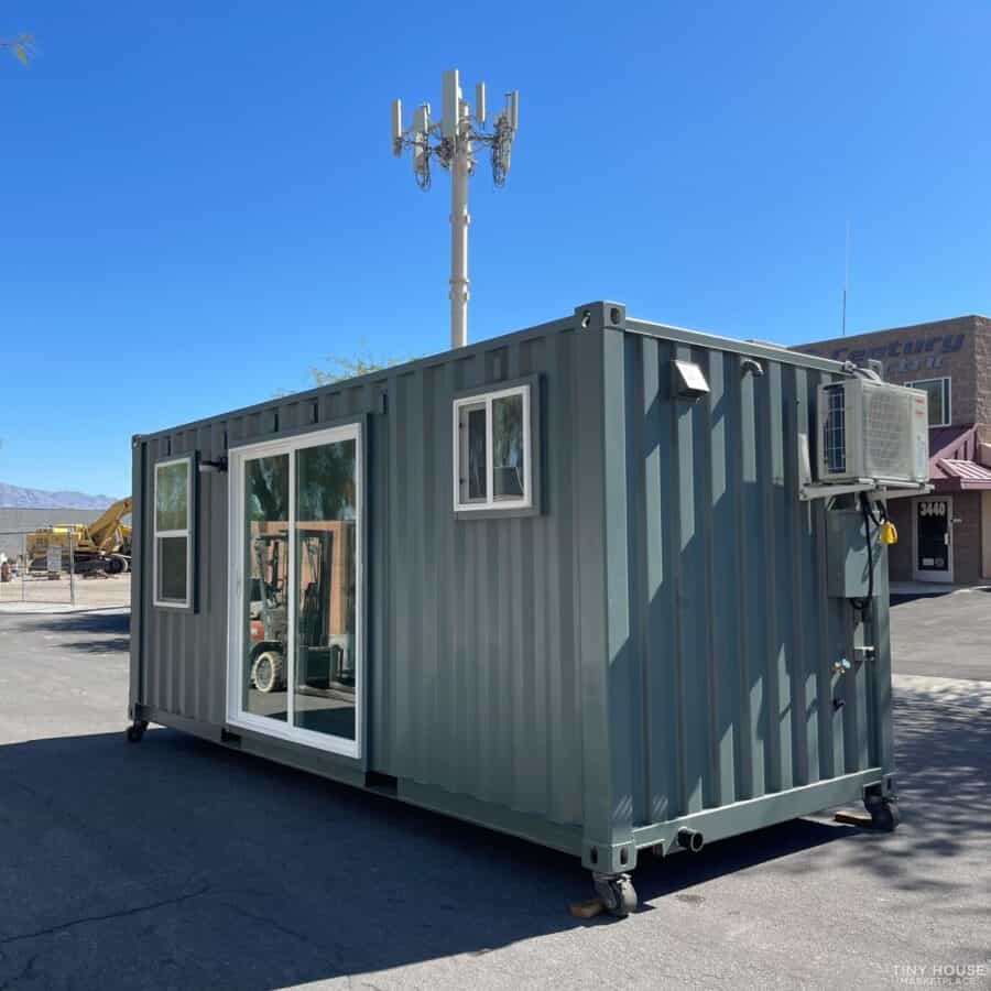 Portable tiny house with large windows and modern design.