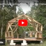 Geodesic dome tiny house under construction in a forest setting.