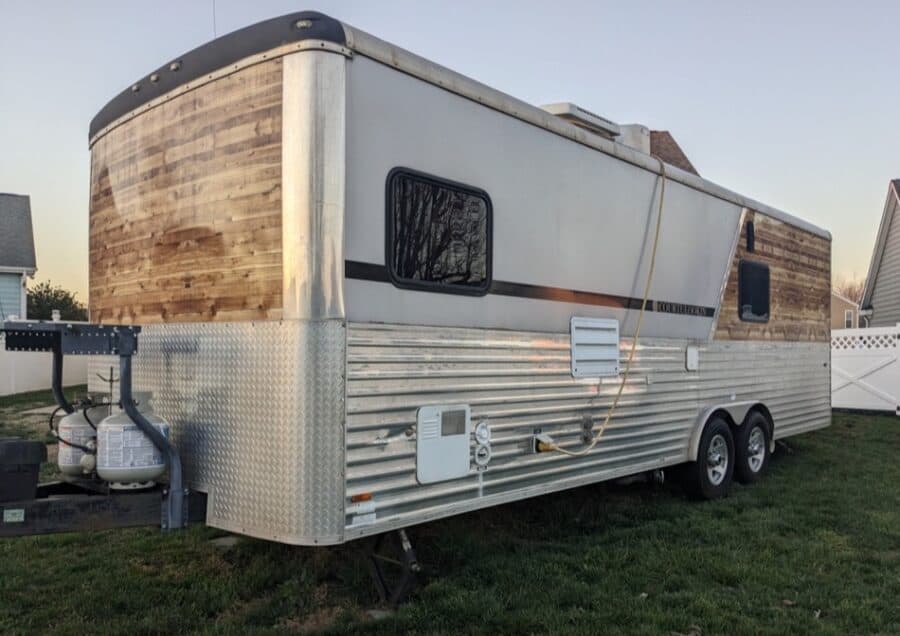Portable tiny house trailer with wood accents and modern amenities.