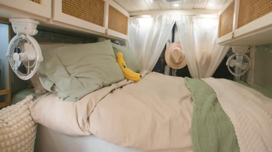 Small cozy bedroom in a tiny house with a parrot on the bed.