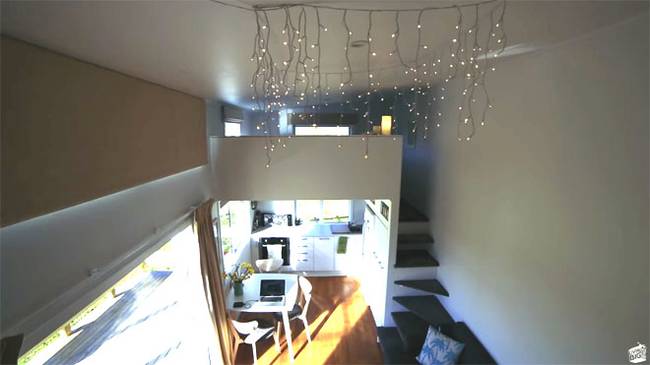 The indoor climbing wall with colorful holds leading to the loft