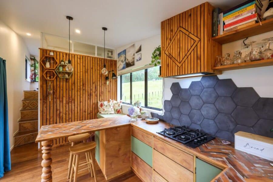Cozy tiny house kitchen with reclaimed wood accents and modern design elements.