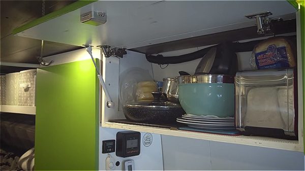 Couple’s Off-Grid, Solar-Powered Van Conversion That They Converted in 36 Days Kitchenette Storage