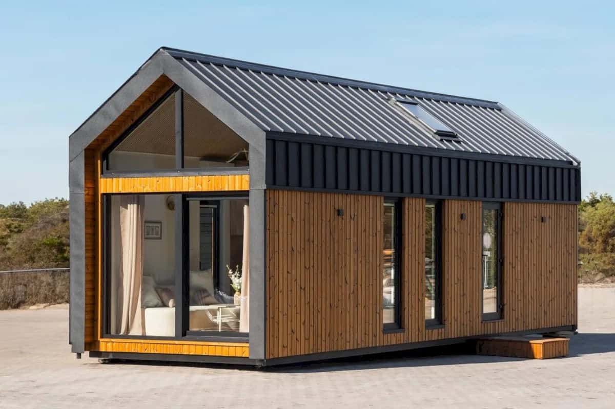 Gable-end exterior of the Lukas modular house by Craft House showing the glass gable and wood-and-metal cladding