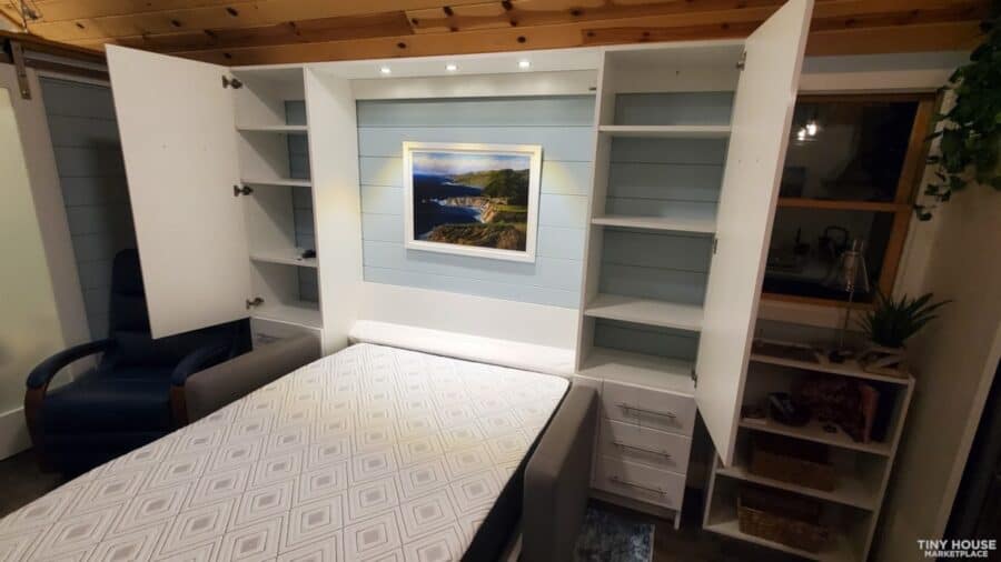 Efficient tiny house design with built-in storage and modern decor.