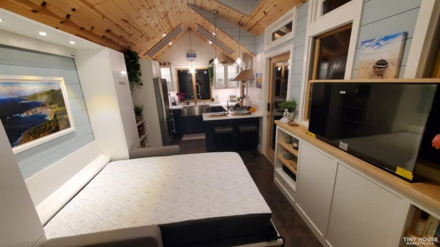 Compact tiny house living space with modern design and efficient layout.