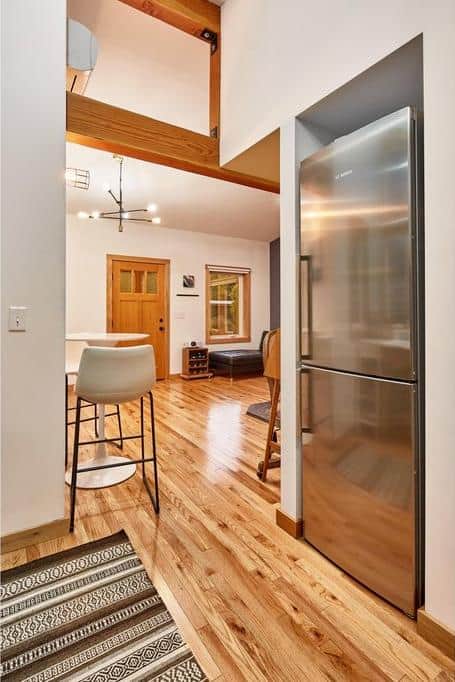 Efficient small space design with modern appliances and warm wooden accents.